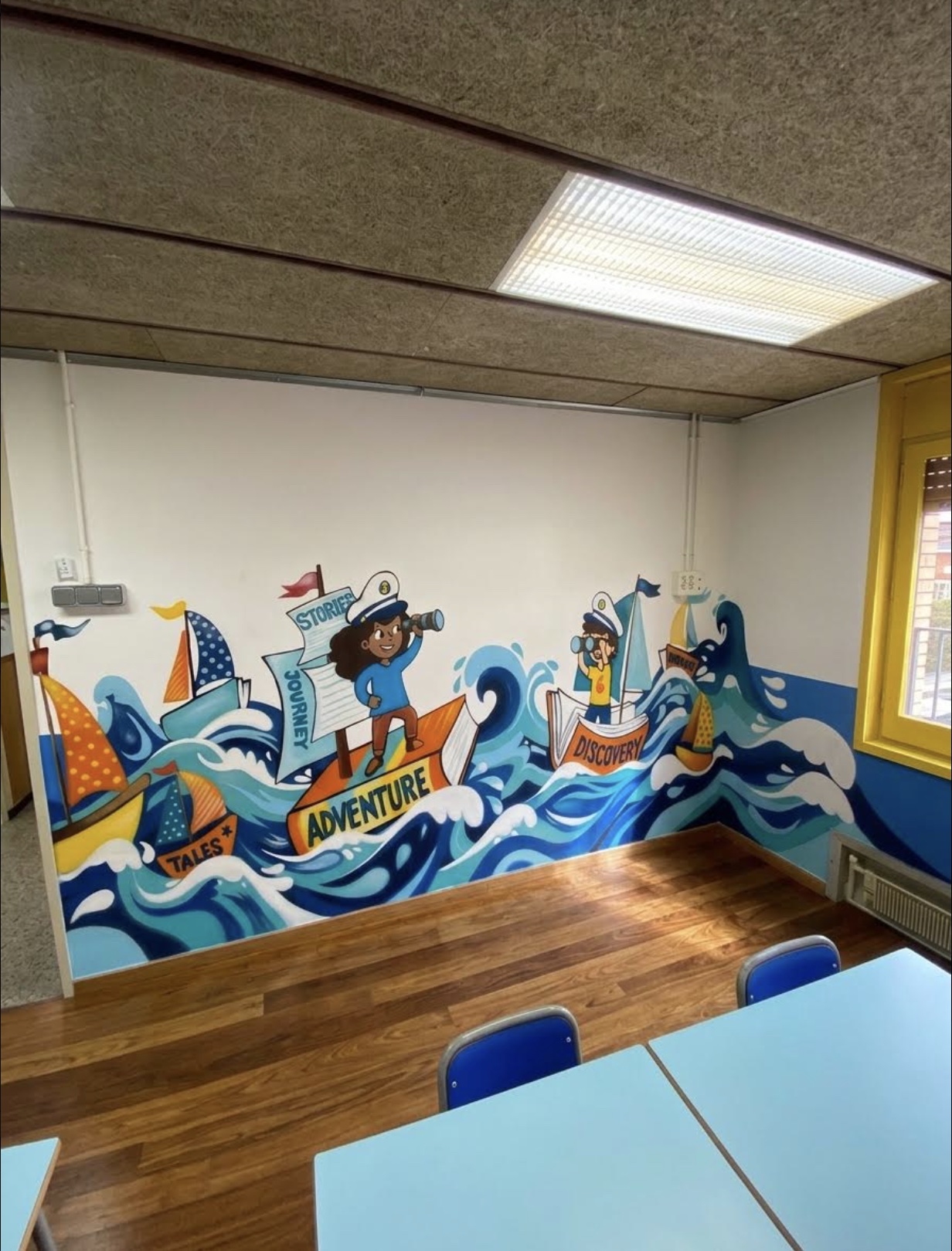 Sailing-ship reading corner mural with Adventure, Discovery and Tales banners